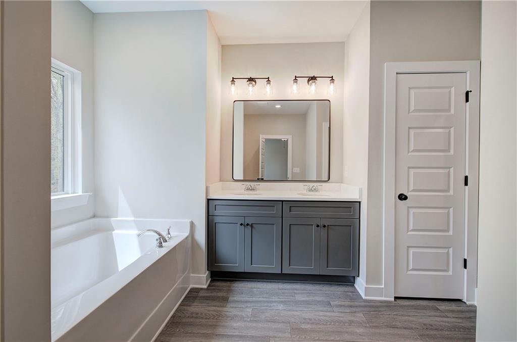 266 Summit Height Drive Cartersville, GA 30121 - Photo 32 of 51 a bathroom with a bathtub sink and mirror