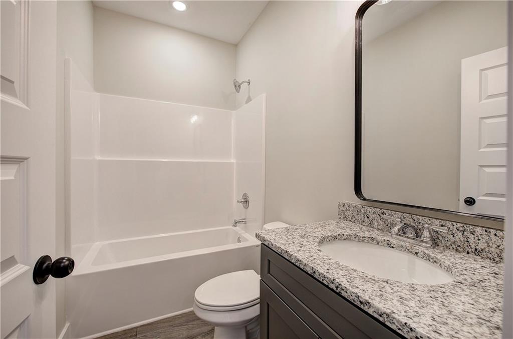 266 Summit Height Drive Cartersville, GA 30121 - Photo 40 of 51 a bathroom with a granite countertop sink a toilet and shower