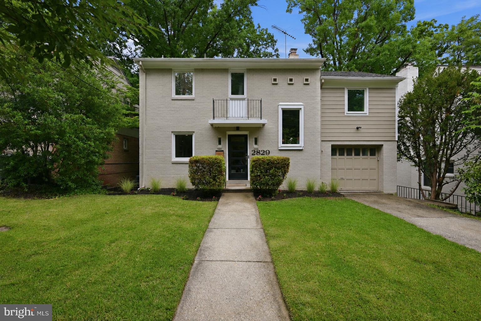 2829 29th Place Northwest Washington, DC 20008 - Photo 1 of 41 a front view of a house with a garden and yard