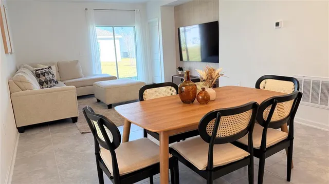a dining room with furniture and window