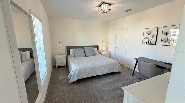 a bedroom with a bed and chair
