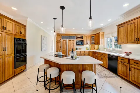 a large kitchen with lots of counter space and windows