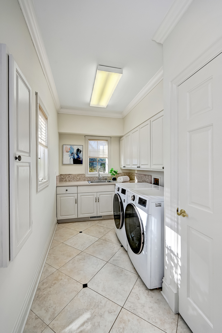 540 Ridgemoor Drive Willowbrook, IL 60527 - Photo 18 of 62 a utility room with cabinets dryer and washer