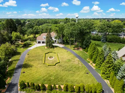 a view of backyard with a table and chairs and potted plants