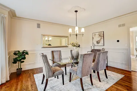 a dining room with furniture potted plants