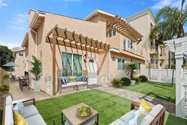 a view of a house with backyard and a patio