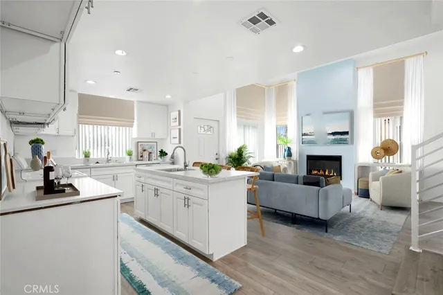 a kitchen with living room and fireplace