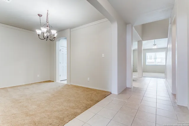 a view of an empty room with a chandelier