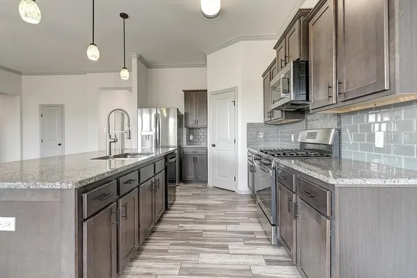 a kitchen with stainless steel appliances granite countertop a sink and stove