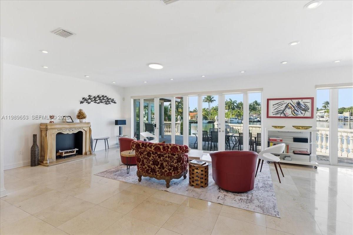 1249 Biscaya Drive Surfside, FL 33154 - Photo 11 of 88 a living room with furniture a fireplace and a floor to ceiling window