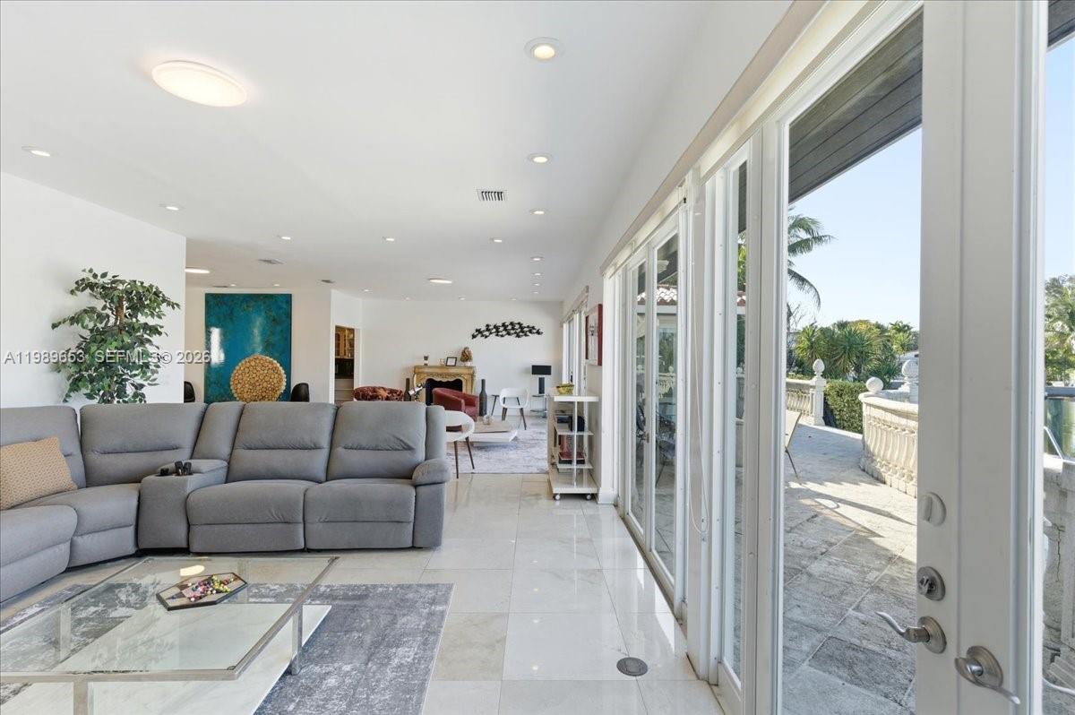 1249 Biscaya Drive Surfside, FL 33154 - Photo 14 of 88 a living room with furniture potted plant and a large window