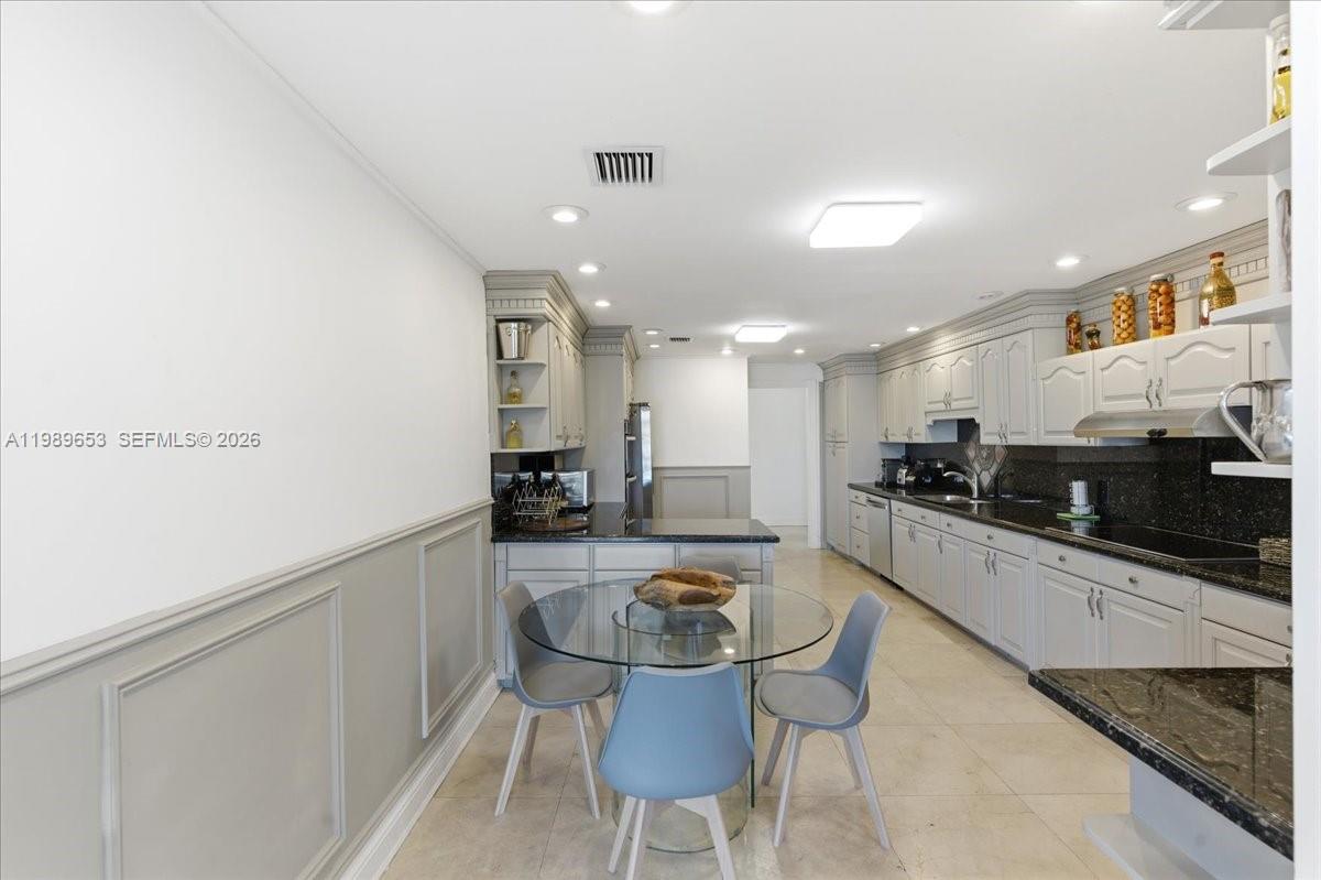 1249 Biscaya Drive Surfside, FL 33154 - Photo 19 of 88 a large kitchen with a table and chairs