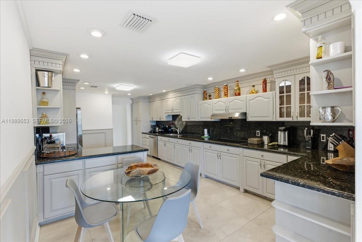 1249 Biscaya Drive Surfside, FL 33154 - Photo 20 of 88 a large kitchen with stainless steel appliances lots of counter space and breakfast area