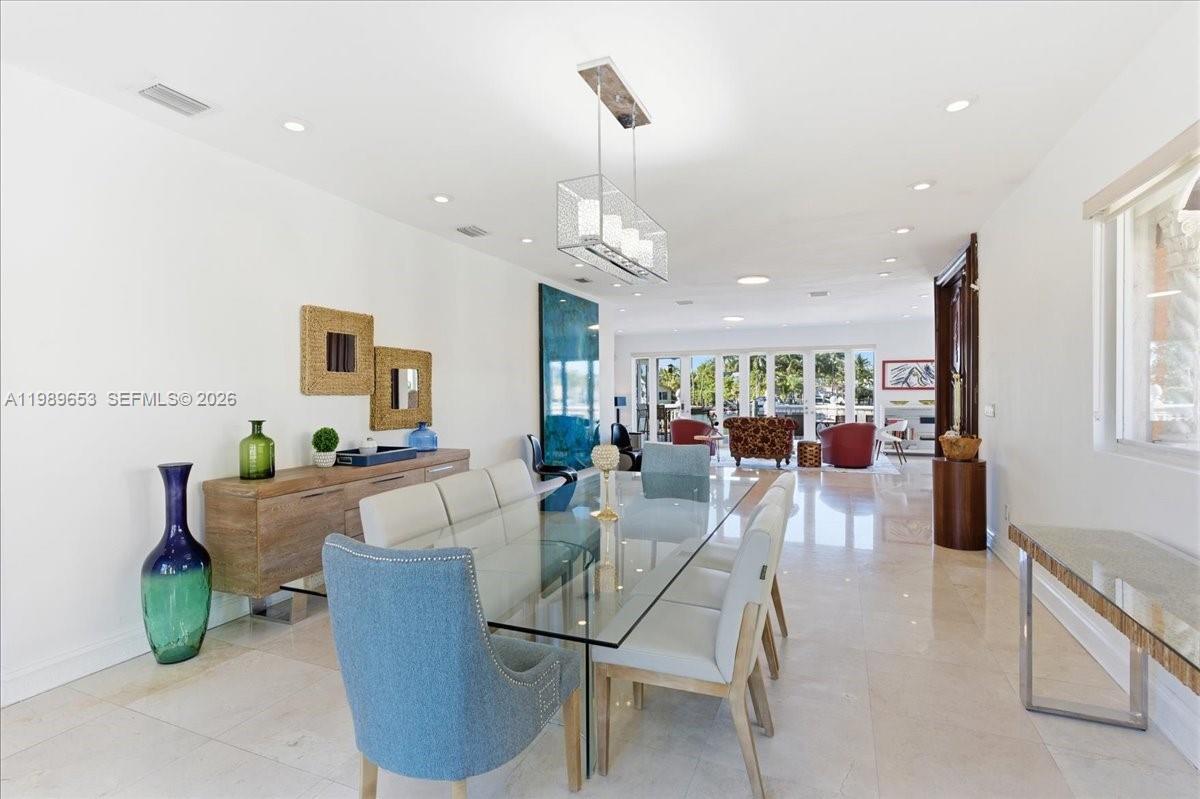 1249 Biscaya Drive Surfside, FL 33154 - Photo 26 of 88 a living room with furniture a chandelier and a dining table