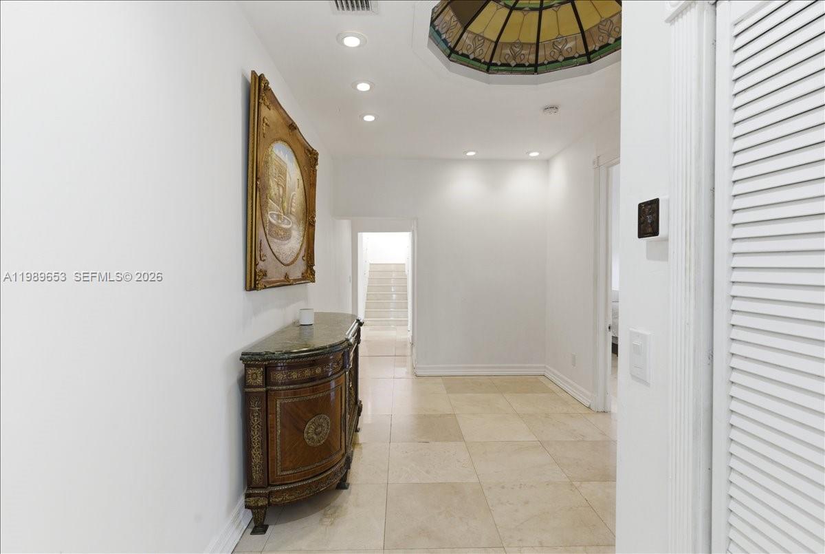 1249 Biscaya Drive Surfside, FL 33154 - Photo 28 of 88 a bathroom with a granite countertop sink and a mirror