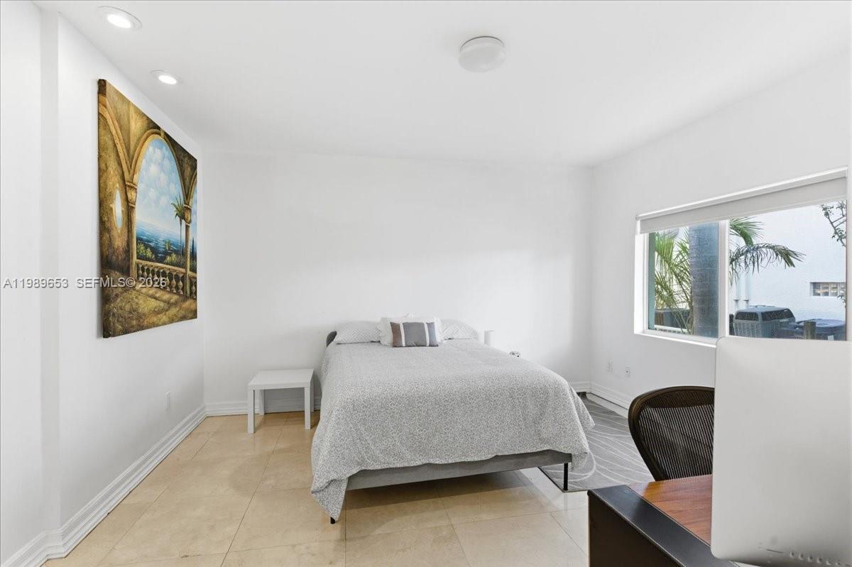 1249 Biscaya Drive Surfside, FL 33154 - Photo 33 of 88 a bedroom with a bed a painting on the wall and a large window