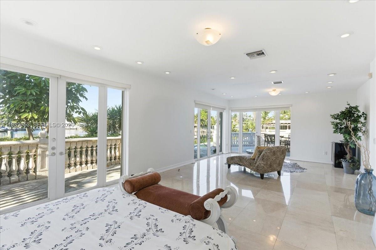 1249 Biscaya Drive Surfside, FL 33154 - Photo 34 of 88 a bedroom with furniture and large windows