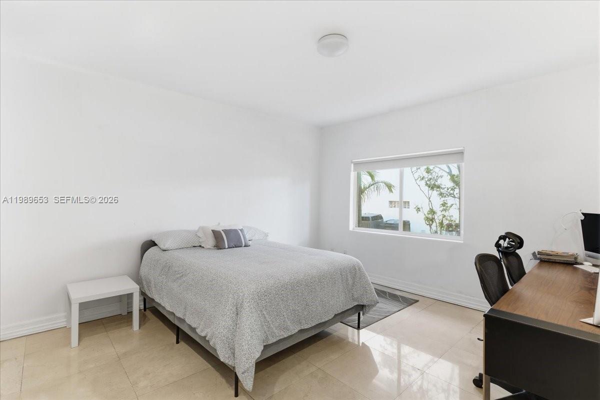 1249 Biscaya Drive Surfside, FL 33154 - Photo 41 of 88 a bedroom with a bed and a desk