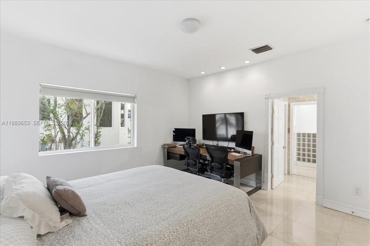 1249 Biscaya Drive Surfside, FL 33154 - Photo 43 of 88 a bedroom with furniture and a flat screen tv