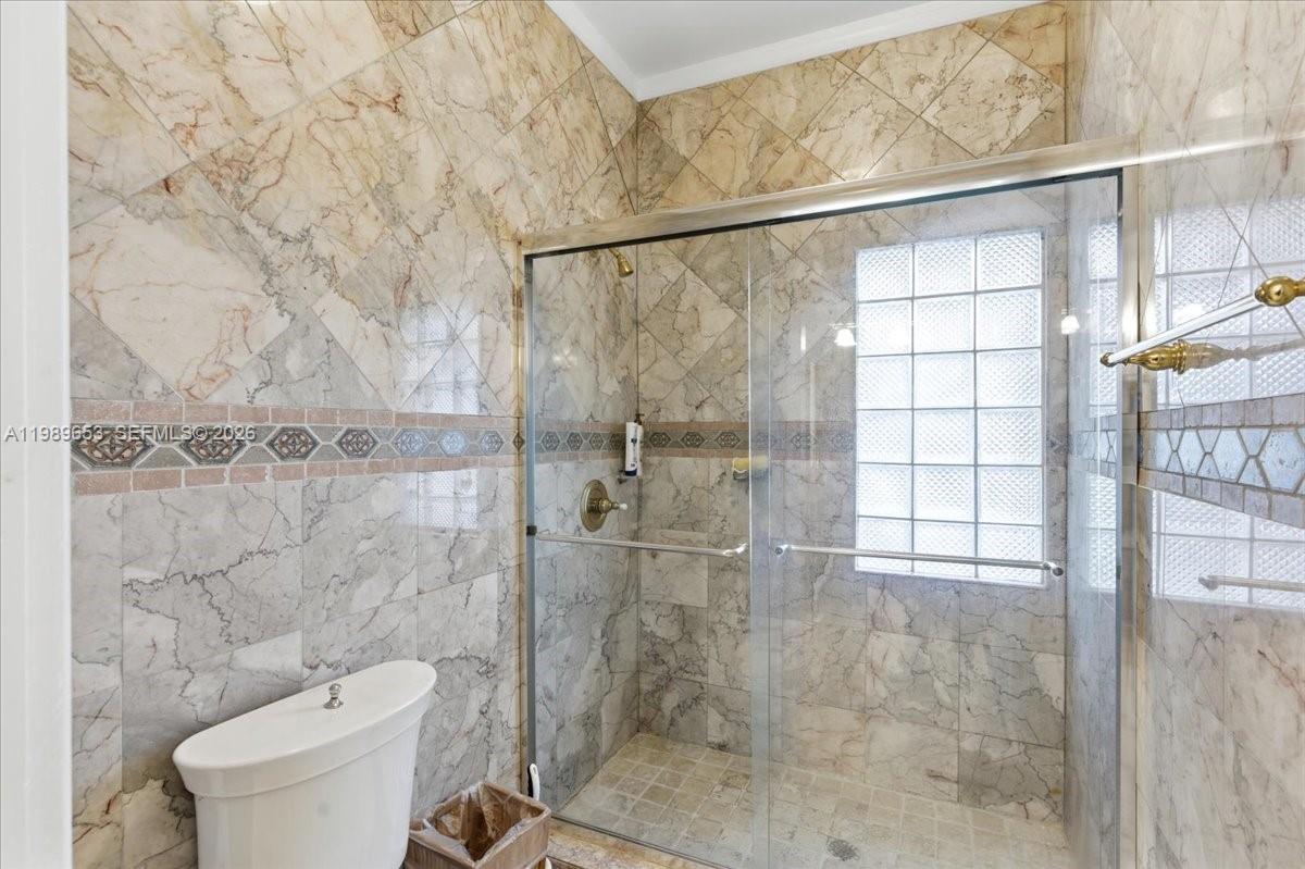 1249 Biscaya Drive Surfside, FL 33154 - Photo 45 of 88 a bathroom with a toilet and a shower