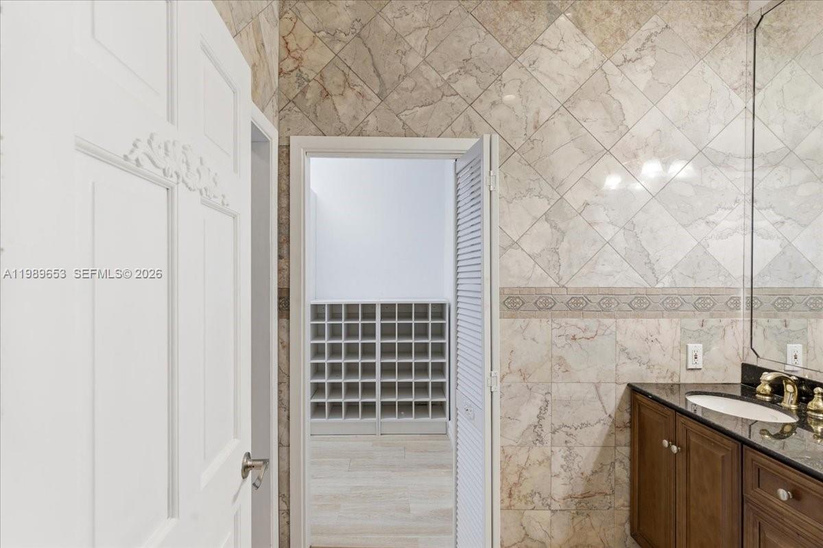 1249 Biscaya Drive Surfside, FL 33154 - Photo 47 of 88 a bathroom with a sink and a mirror
