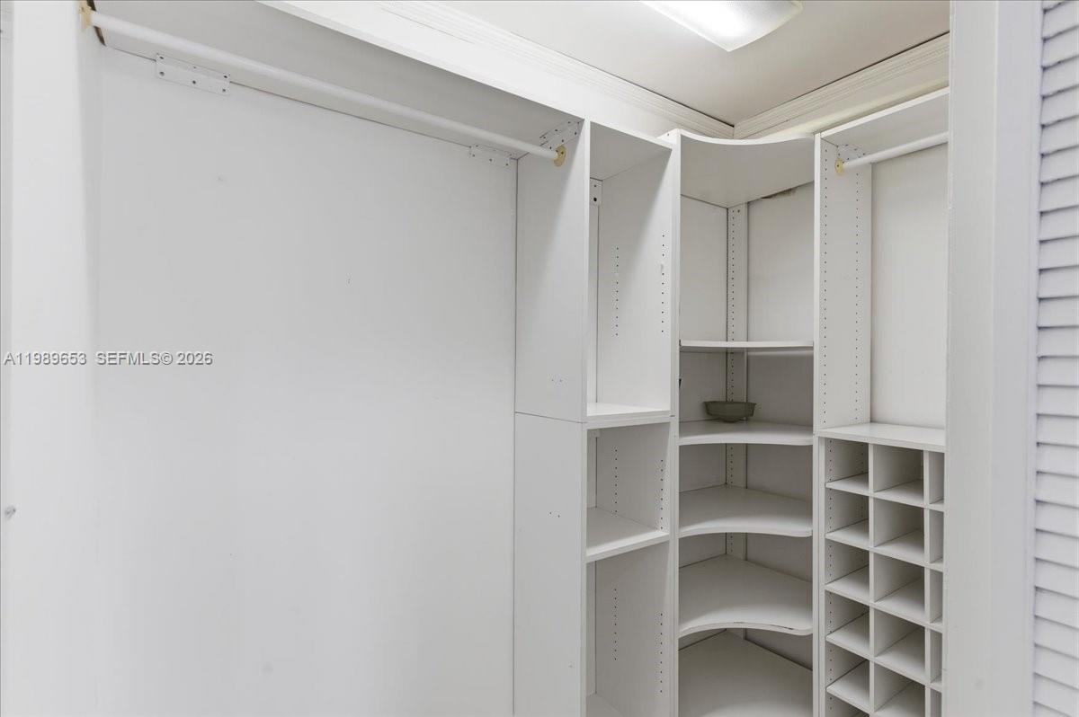 1249 Biscaya Drive Surfside, FL 33154 - Photo 50 of 88 a view of walk in closet with empty racks