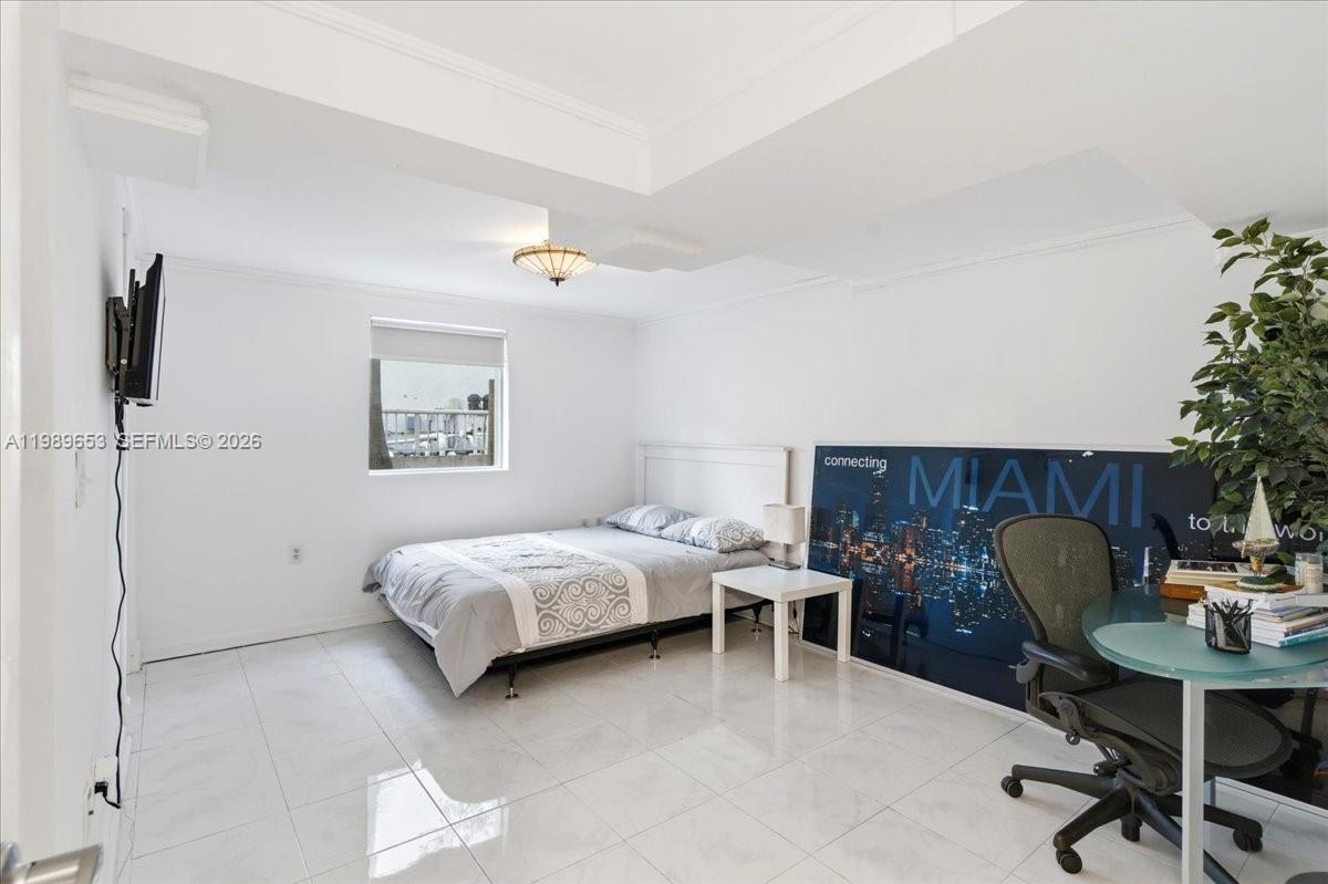 1249 Biscaya Drive Surfside, FL 33154 - Photo 56 of 88 a bedroom with a bed and a desk