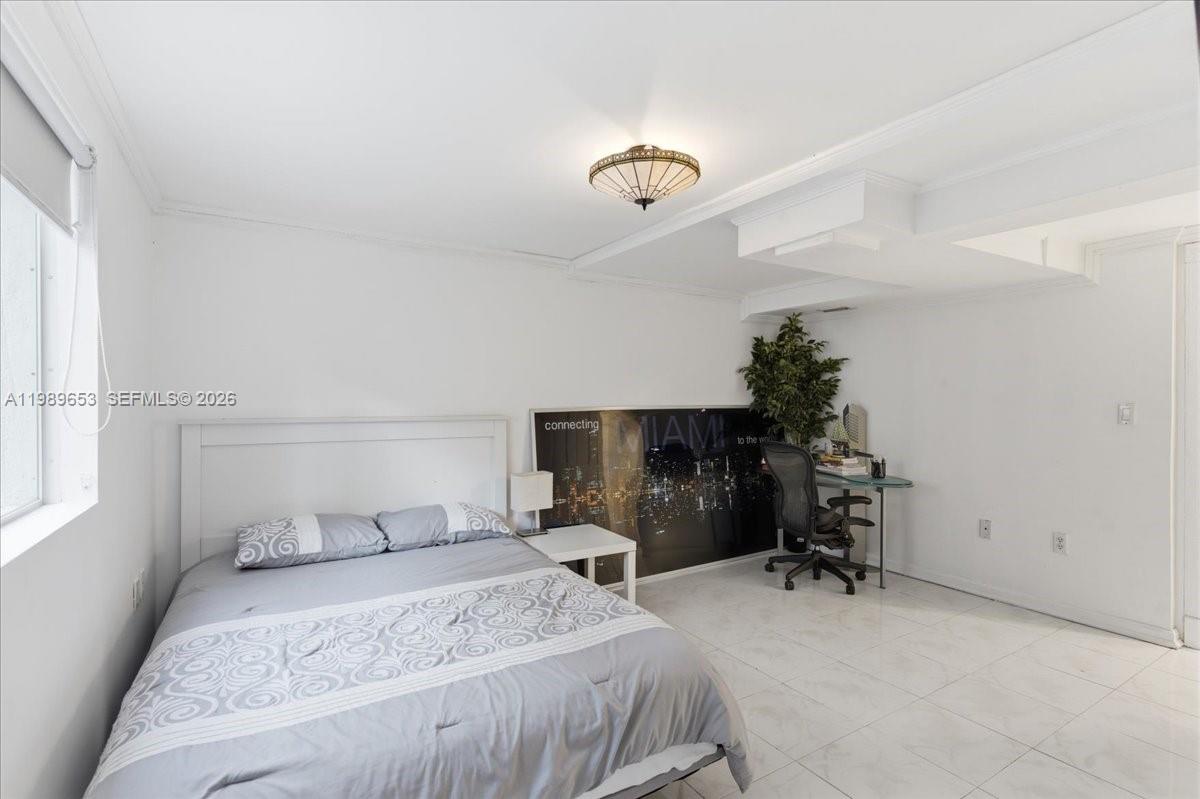 1249 Biscaya Drive Surfside, FL 33154 - Photo 57 of 88 a bedroom with a bed and a chair