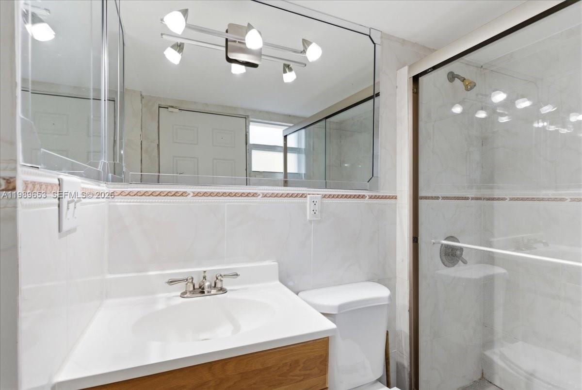 1249 Biscaya Drive Surfside, FL 33154 - Photo 58 of 88 a bathroom with a sink a light fixture and a toilet