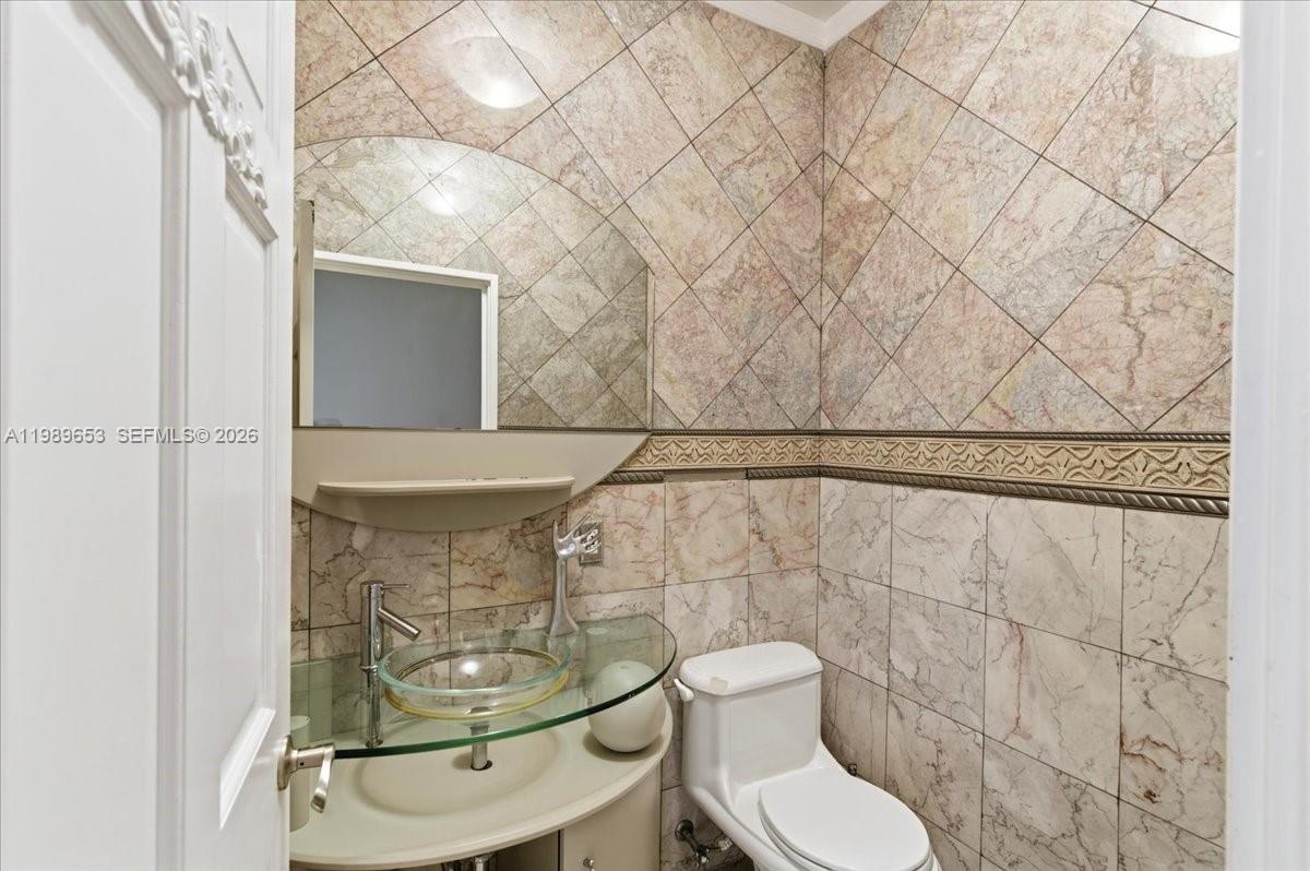 1249 Biscaya Drive Surfside, FL 33154 - Photo 60 of 88 a bathroom with a toilet and a shower