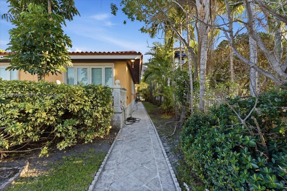 1249 Biscaya Drive Surfside, FL 33154 - Photo 68 of 88 a front view of a house with a yard and potted plants