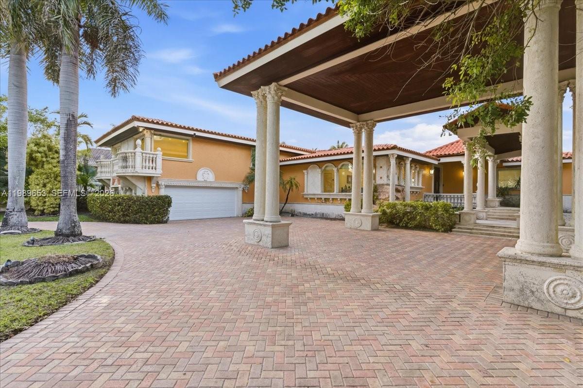 1249 Biscaya Drive Surfside, FL 33154 - Photo 83 of 88 a front view of a house with garden