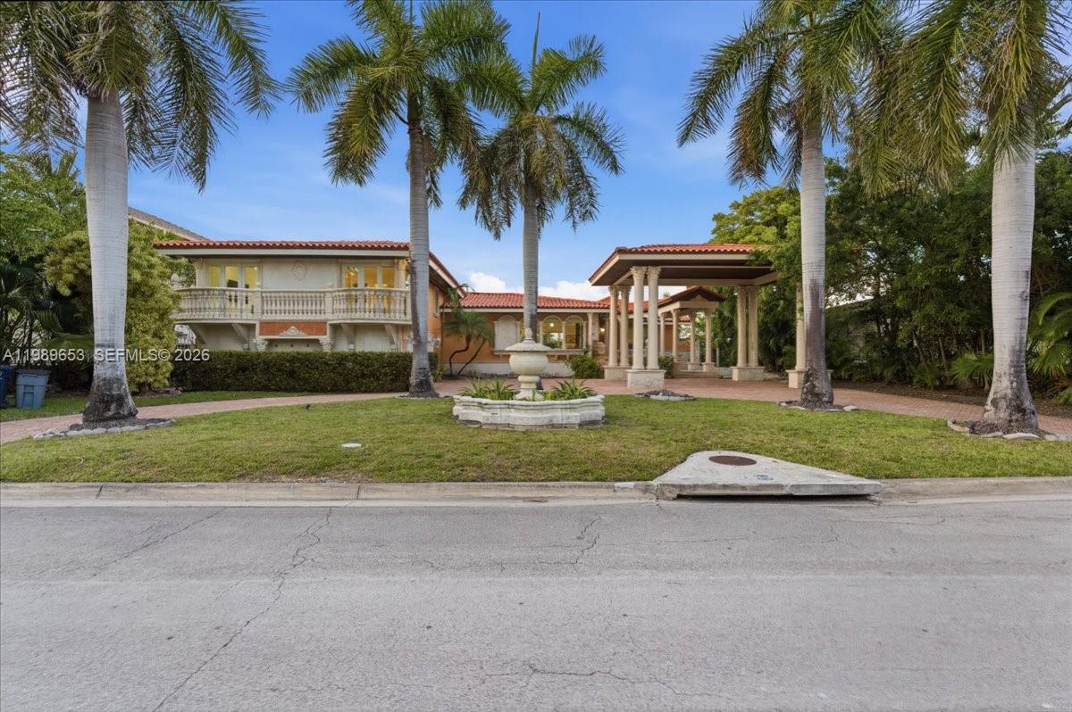 1249 Biscaya Drive Surfside, FL 33154 - Photo 84 of 88 a view of a house with a yard and palm trees