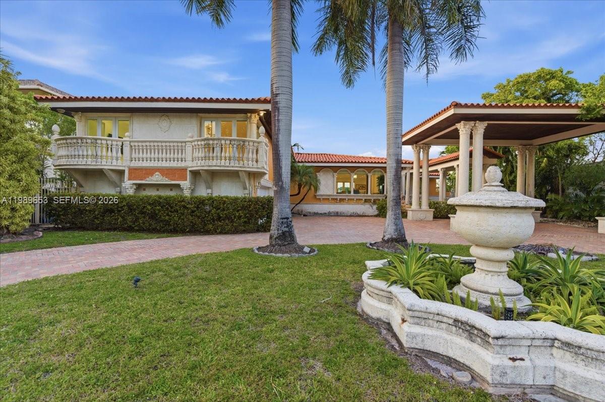 1249 Biscaya Drive Surfside, FL 33154 - Photo 85 of 88 a front view of a house with a garden
