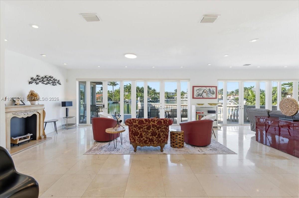 1249 Biscaya Drive Surfside, FL 33154 - Photo 10 of 88 a living room with furniture a fireplace and a floor to ceiling window