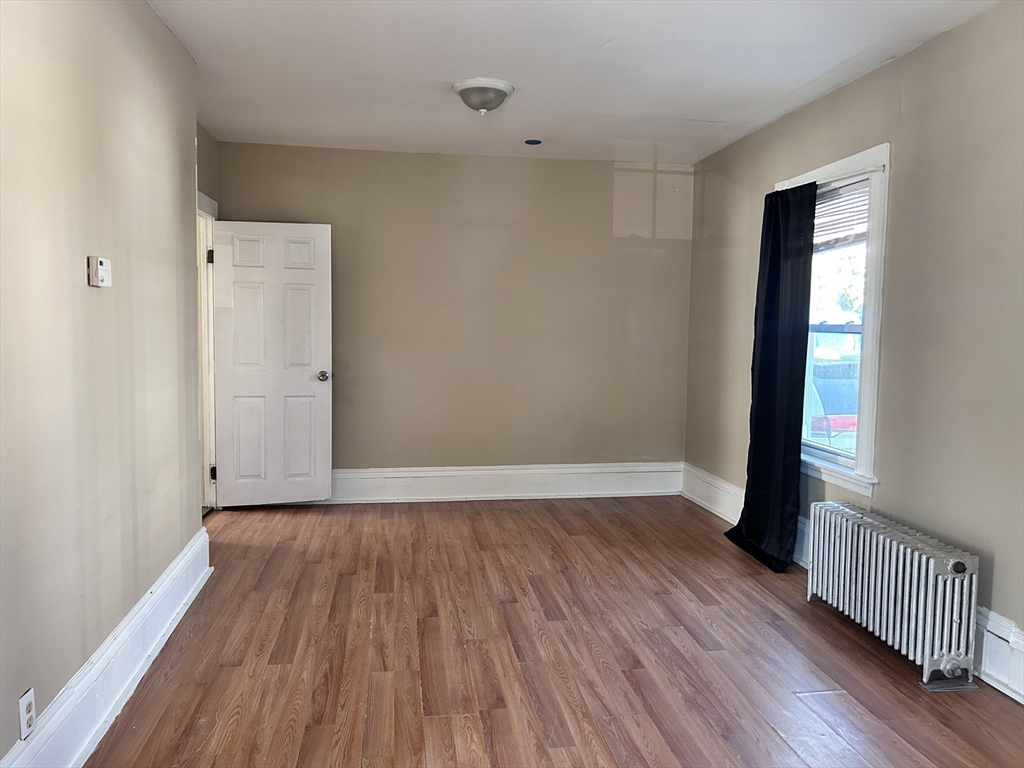 a view of a room with wooden floor and windows