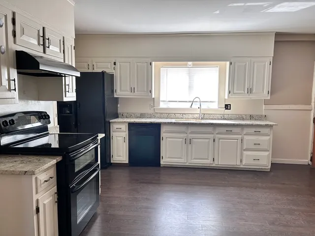 a kitchen with a sink stove and refrigerator