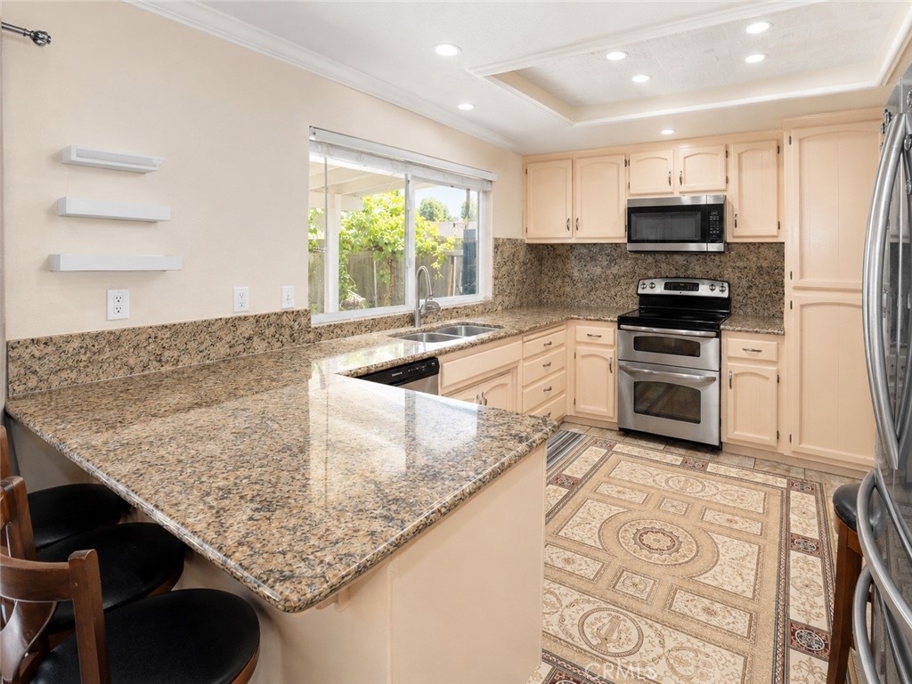 4100 Ahwahnee Court Modesto, CA 95356 - Photo 10 of 34 Spacious kitchen with large counter space and bright backyard-facing window.