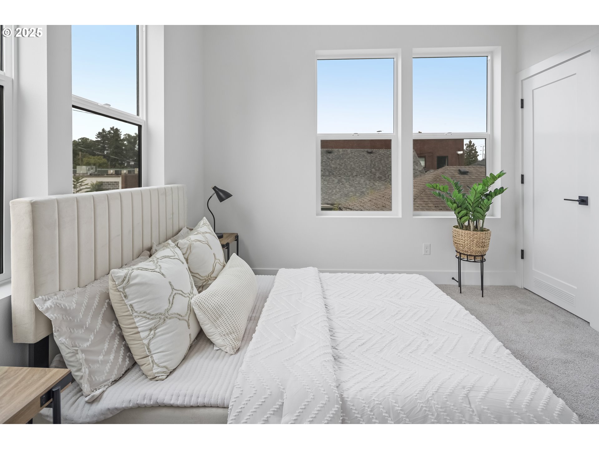 4732 Southeast 65th Avenue Portland, OR 97206 - Photo 11 of 16 a bedroom with a bed windows and a potted plant