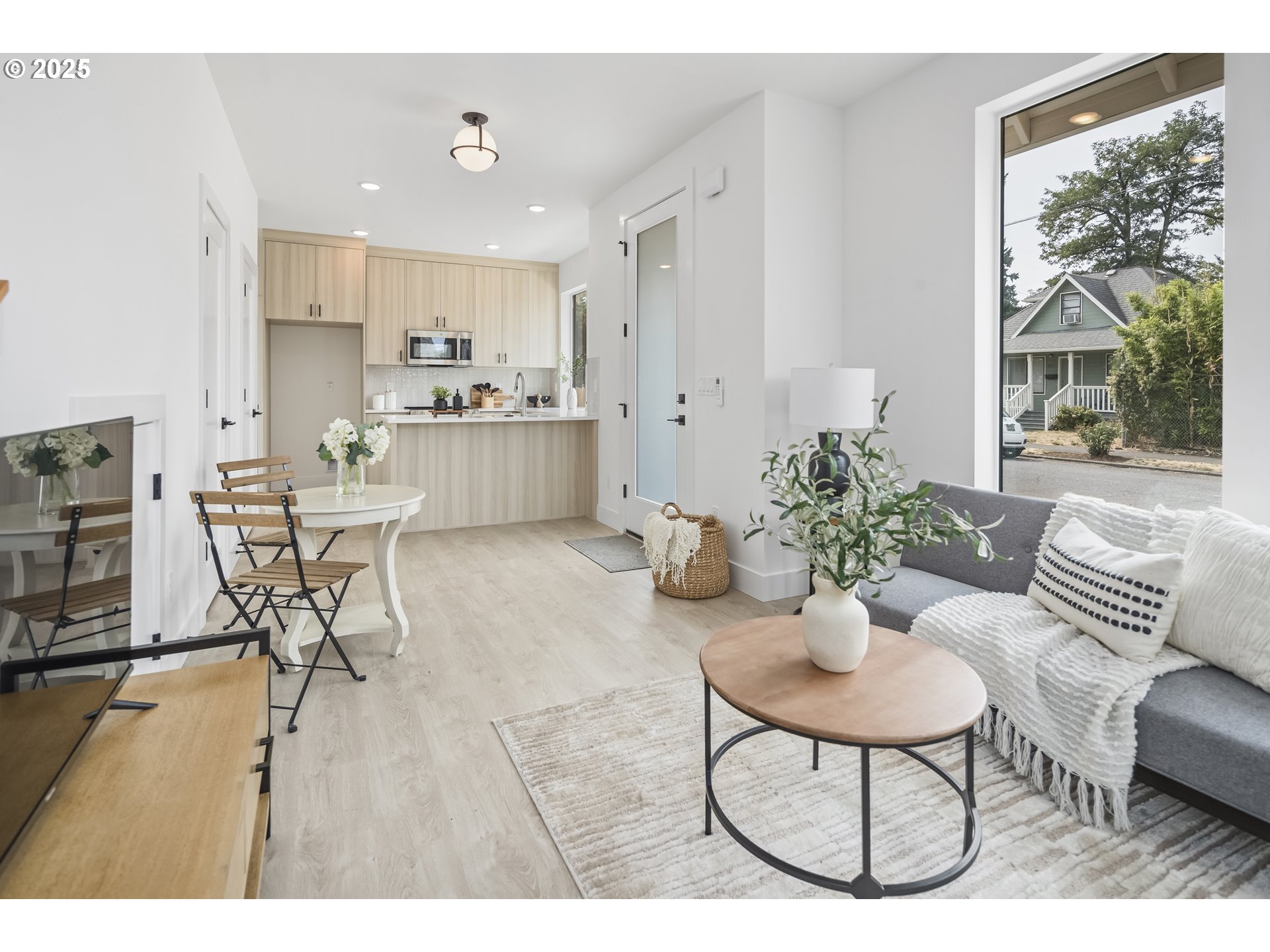 4732 Southeast 65th Avenue Portland, OR 97206 - Photo 8 of 16 a living room with furniture and a dining table with kitchen view