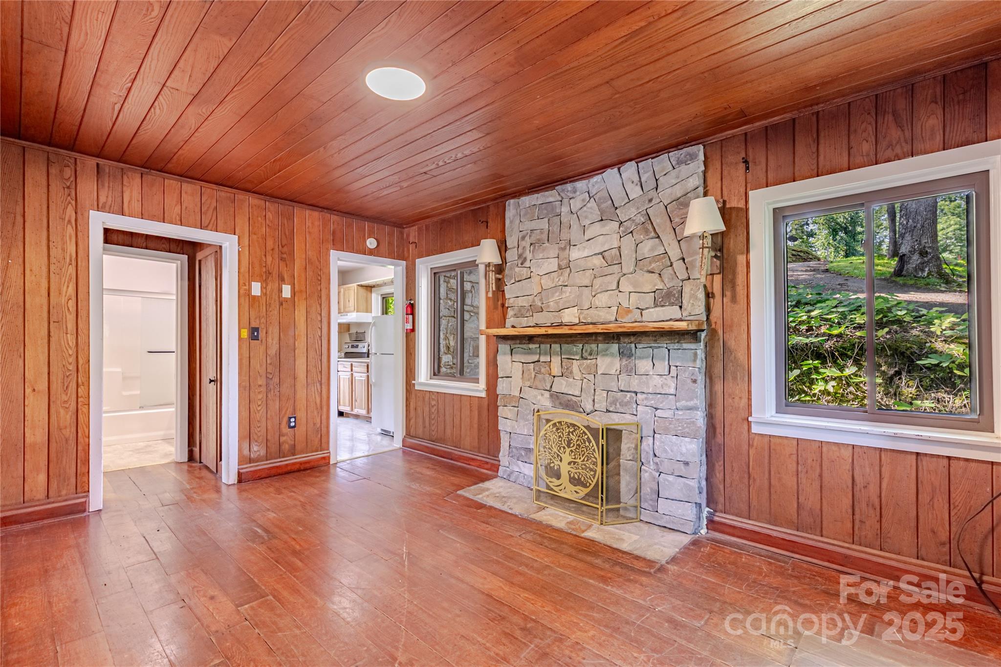 160 Observation Point Road Bryson City, NC 28713 - Photo 6 of 26 an empty room with wooden floor fireplace and windows