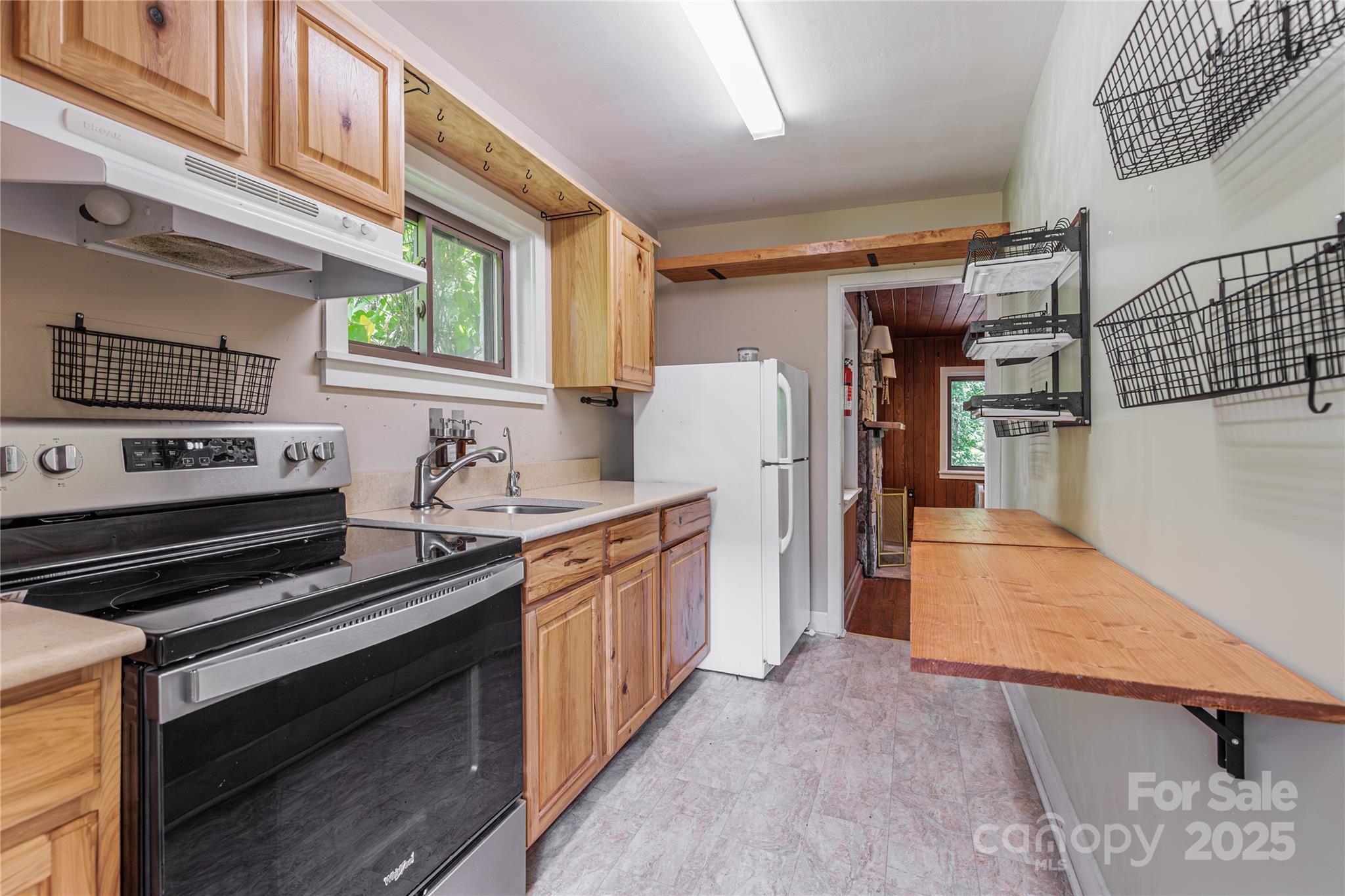 160 Observation Point Road Bryson City, NC 28713 - Photo 9 of 26 a kitchen with stainless steel appliances granite countertop a stove and a refrigerator