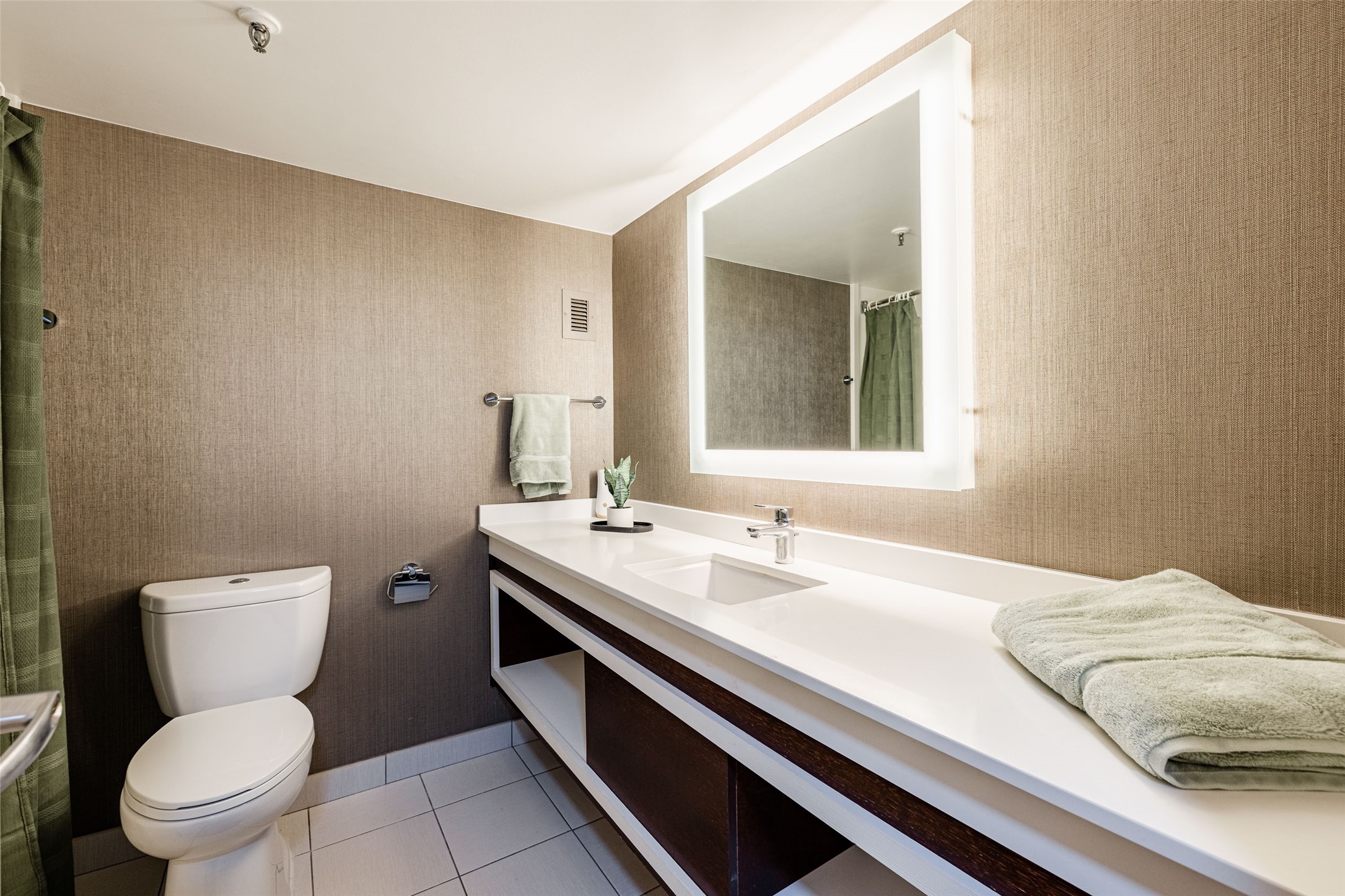 14703 Park Row Houston, TX 77079 - Photo 4 of 40 a bathroom with a granite countertop toilet sink and mirror