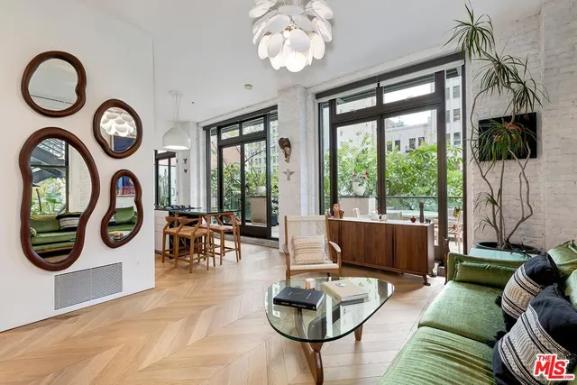 a living room with furniture and a floor to ceiling fan