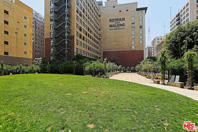 a backyard of a house with stainless steel appliances wooden floor and brick wall