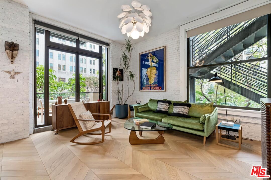 460 South Spring Street, Unit 201 Los Angeles, CA 90013 - Photo 2 of 27 a living room with furniture and a large window