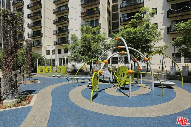 a view of a hallway with couches and chandelier