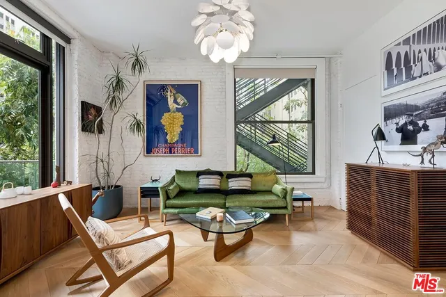 a living room with fireplace furniture and a large window