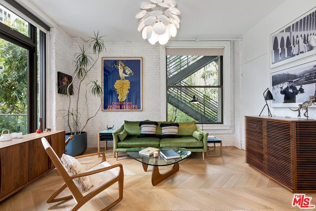 460 South Spring Street, Unit 201 Los Angeles, CA 90013 - Photo 3 of 27 a living room with fireplace furniture and a large window