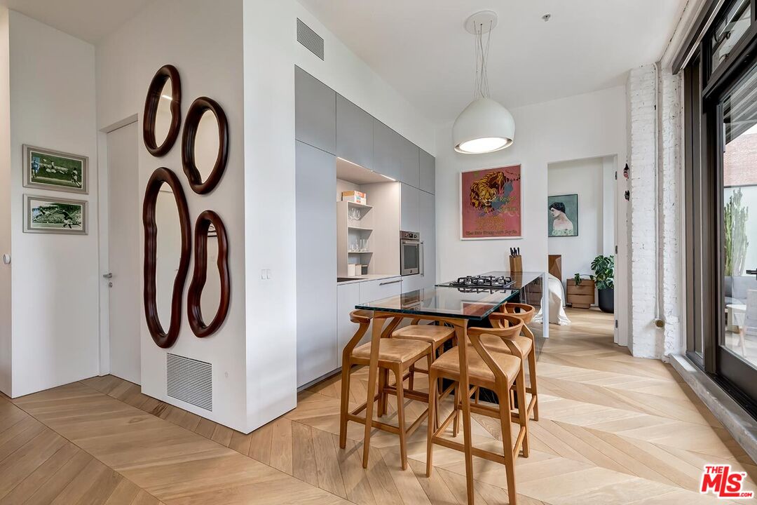 460 South Spring Street, Unit 201 Los Angeles, CA 90013 - Photo 5 of 27 a view of a dining room with furniture and a chandelier